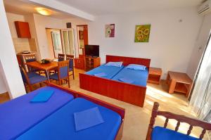 a bedroom with a bed and a table and chairs at Apartments Scorpio in Kotor