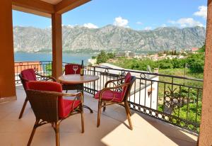 a balcony with a table and chairs and a view at Apartments Scorpio in Kotor