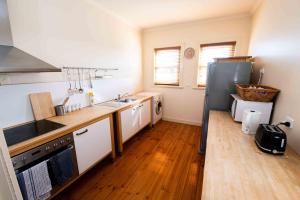 a kitchen with a refrigerator and a wooden floor at Park Hotel in Mount Gambier