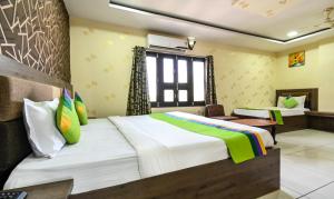 Ein Bett oder Betten in einem Zimmer der Unterkunft Treebo Siddharth