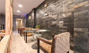 a brick wall in a restaurant with a table and chairs at Treebo Trend Siddharth in Ajmer