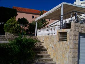 a stone stairway leading to a house with a gate at Apartment Tuja in Jadrtovac