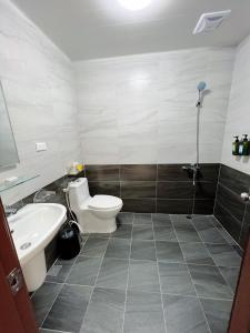 a bathroom with a toilet and a sink at Mu Travel B&B in Kenting
