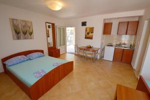 a large bedroom with a bed and a kitchen at Apartments Scorpio in Kotor