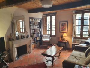 a living room with a couch and a fireplace at La Maison Provençale in La Roquebrussanne