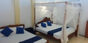 Letto o letti in una camera di Ocean Gate Villa Tangalle