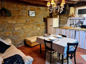 a dining room with a table and a kitchen at CASA VILLANOVA homes in Nova Vas nad Dragonjo
