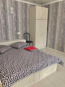 a bedroom with a bed with a black and white comforter at Apartment квартира Ярослава Мудрого in Kryvyi Rih