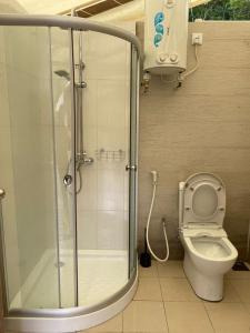 a bathroom with a shower and a toilet at Canopy Villa Tampik Valley in Kampong Sum Sum