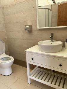 a bathroom with a white sink and a toilet at Canopy Villa Tampik Valley in Kampong Sum Sum
