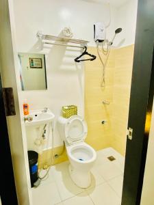 a small bathroom with a toilet and a sink at Happy Homes Manila in Manila