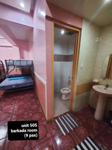 a small bathroom with a bed and a toilet at ASHBURN'S TRANSIENT BAGUIO - BASIC SLEEP and GO, LIMITED PAY PARKING, SELF SERVICE in Baguio +239 photos