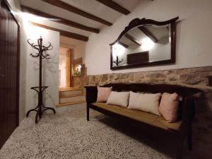 a living room with a couch and a mirror at Cal Sabater, la teva llar lluny de casa in Preixana