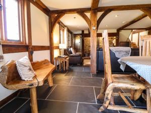 a living room with a table and a chair at The Old House in Llanidloes