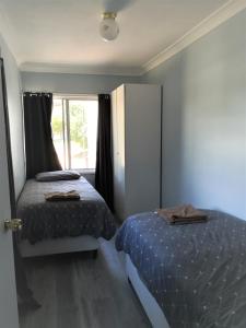 a bedroom with two beds and a window at So close to Birubi Beach in Anna Bay