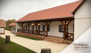 a house with a red roof and a pavilion at Végvári Vendégház in Magyarbóly +48 photos
