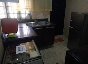 una piccola cucina con lavandino e piano di lavoro di XrisBun Apt 1BR - Laderin GRA ad Abeokuta Altre 3 foto
