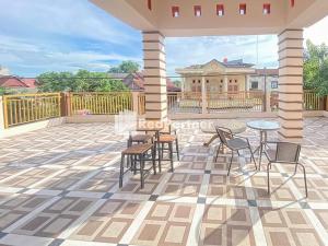 eine Terrasse mit Stühlen und Tischen auf der Terrasse in der Unterkunft Homestay Tirtasari Pinrang City Center Mitra RedDoorz in Pinrang