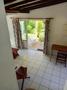 a view of a room with a table and chairs at Maison charmante Grand-Bourg in Grand-Bourg