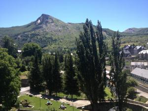 a park with trees and a mountain in the background at Hostal Centro in Sallent de Gállego