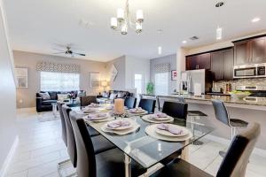 a dining room and living room with a table and chairs at Luxurious 5BR Villa in Champions Gate Resort in Davenport