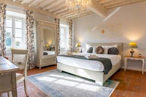 a bedroom with a large bed and a mirror at Villa La Preziosa in Lucca