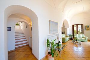 a living room with white walls and a staircase at Villa Aristide Amalfi Coast - POOL in Praiano