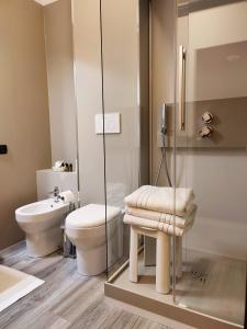 a bathroom with a toilet and a glass shower at Hotel Cristallo in Conegliano