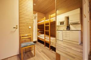a small apartment with bunk beds in a room at Heinolan Heinäsaari - Holiday and Camping in Heinola