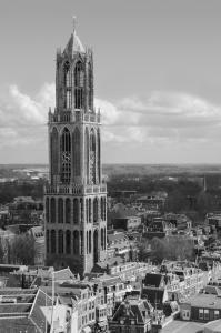 
a tall clock tower towering over a city at Eye Hotel in Utrecht
