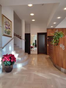 a hallway with stairs and flowers in a building at Hotel Cristallo in Conegliano