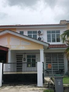 a house with a palm tree in front of it at Nara Homestay Serkam in Merlimau