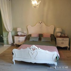 a bedroom with a large white bed and two night stands at CasaBoutique cerca del mar con vistas a la montaña in Polop