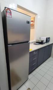 a stainless steel refrigerator in a kitchen at 3min MITEC KL Publika Ocean Classic Condo 2308 in Kuala Lumpur
