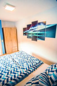 a bedroom with four paintings on the wall at Rheinterrasse Wohnung 1 in Lahnstein