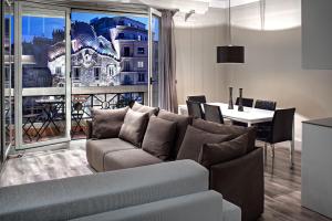 a living room with a couch and a table at Habitat Apartments Paseo de Gracia in Barcelona