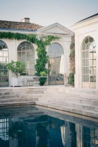 a house with a swimming pool in front of it at Château du Tertre in Arsac