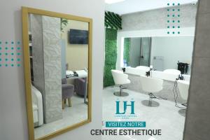 uma imagem de uma casa de banho com um espelho em Larimar Hôtel Sfax em Sfax