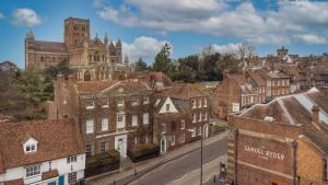 a view of a city with buildings and a cathedral at The Samuel Ryder Hotel St Albans, Tapestry Collection Hilton in St. Albans