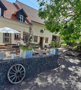 a house with aokedoked wheel in front of a building at Ferienhaus Schiffweiler-Stennweiler in Schiffweiler