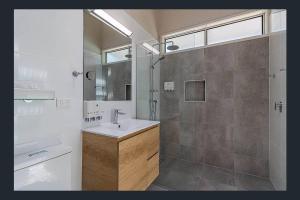 a bathroom with a sink and a shower at Kookaburra Villa at Kingfisher Bay Resort in Kingfisher Bay +16 photos