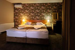 Posteľ alebo postele v izbe v ubytovaní Lugas Hotel