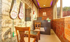 a small room with a table and two chairs at Treebo Trend Berry Hill Venna Lake 3 Km From City Center in Mahabaleshwar