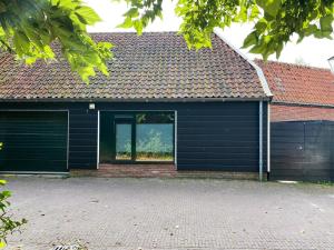 a garage with a large window in a house at Vakantiewoning Veere VE01 in Veere