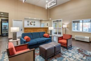 a living room with a blue couch and two chairs at Comfort Suites Keeneland in Lexington