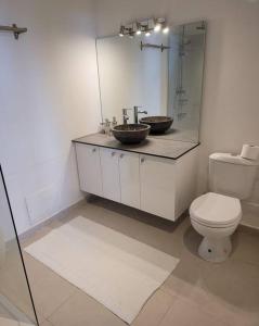 a bathroom with a toilet and a sink and a mirror at Hello Guyane(3), Suite Prestige Premium, 5 étoiles in Cayenne