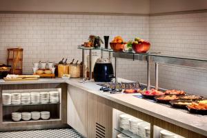 a kitchen with food on a counter in a restaurant at Leonardo Hotel Manchester Piccadilly in Manchester +52 photos