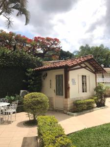 a small house with a gate and a patio at Pousada Sossego da Pampulha in Belo Horizonte