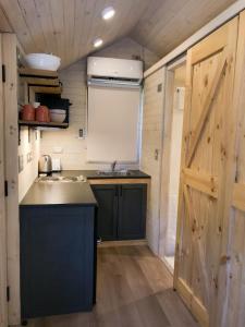 a small kitchen with a sink and a door at Cabañas Monte Verde in Pucón