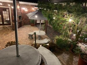 an overhead view of a patio with a table and an umbrella at Green Pastures Guesthouse in George